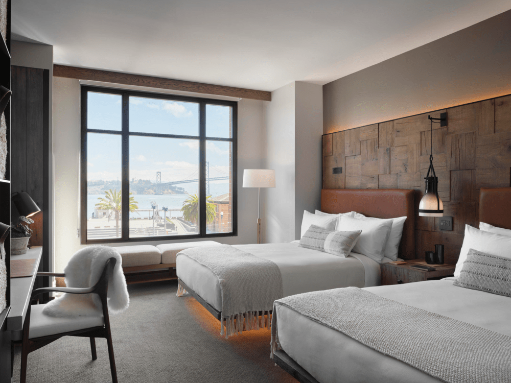 Hotel room with two queen beds and a bay view window